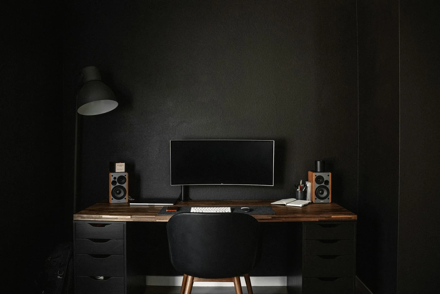 A desktop computer in a softly lit home workspace