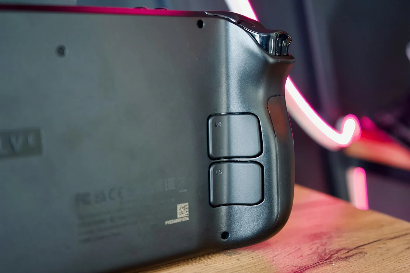 Close-up of the rear grip and programmable buttons on a Steam Deck handheld