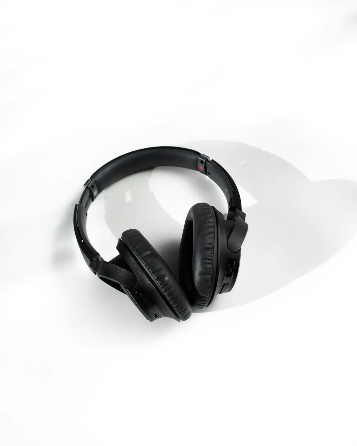 Black over-ear wireless headphones on a light surface