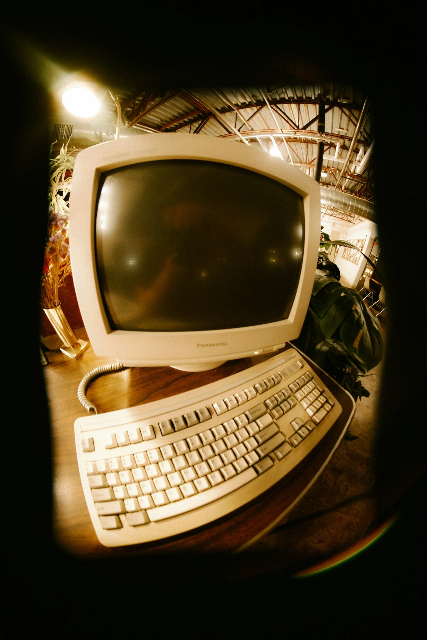 A vintage CRT computer monitor and keyboard on a desk
